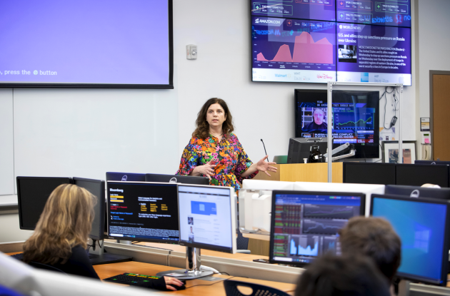 Tish O'Connor teaches in smart lab in front of screens.