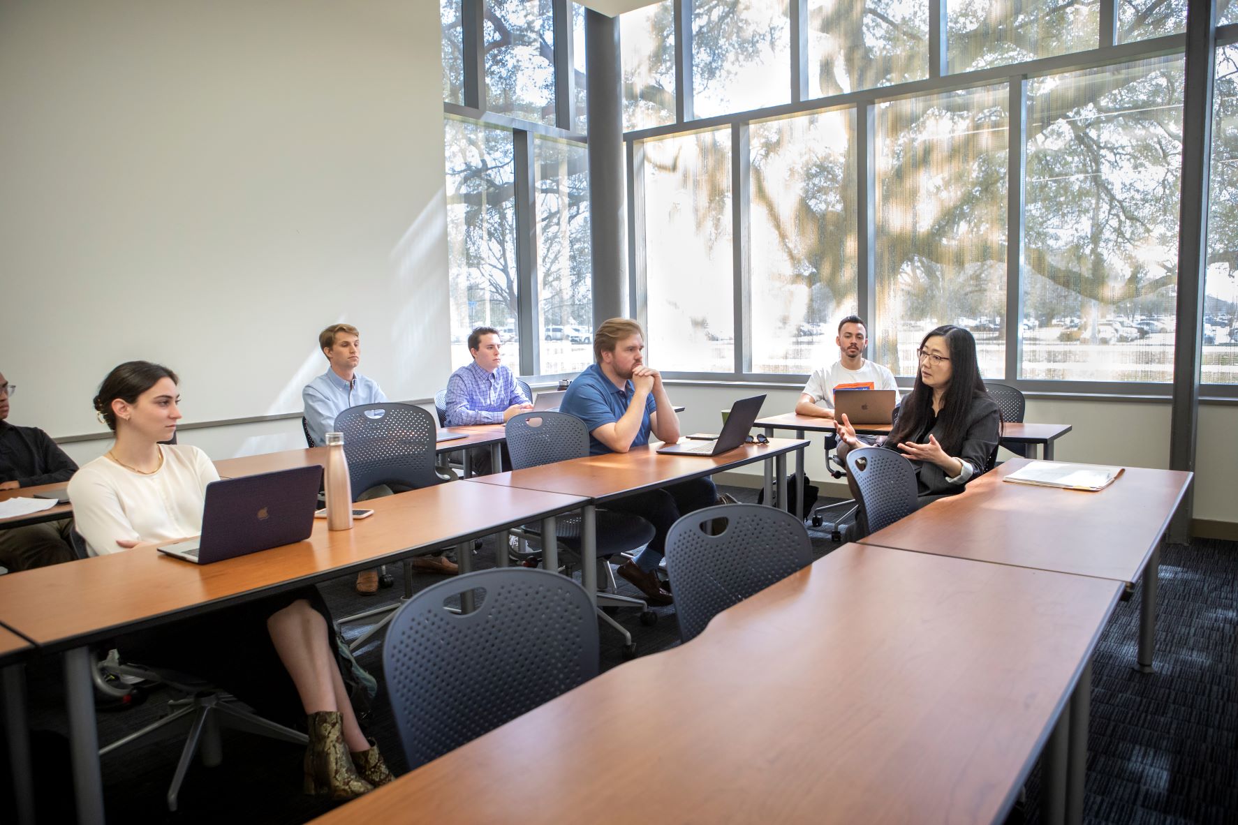 small classroom with graduate students having a discussion with faculty