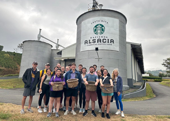 Group of accounting stdents in front of Starbucks facility in Costa Rica