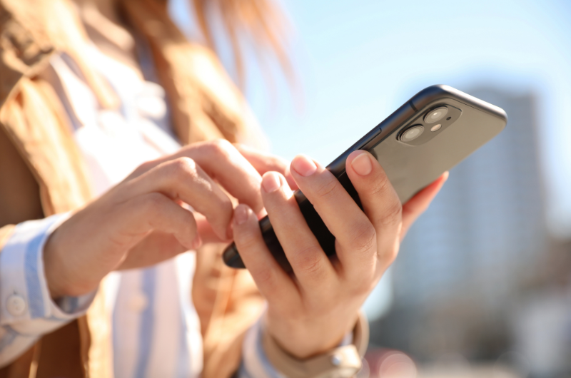 student holding iphone