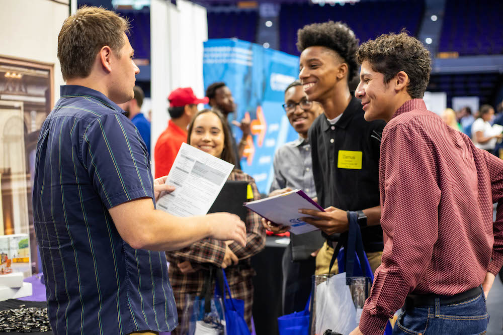 students talking to employer