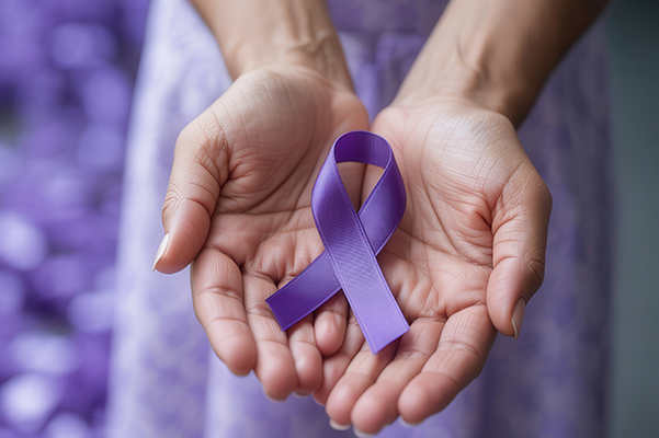Photo of two hands holding a purple ribbon