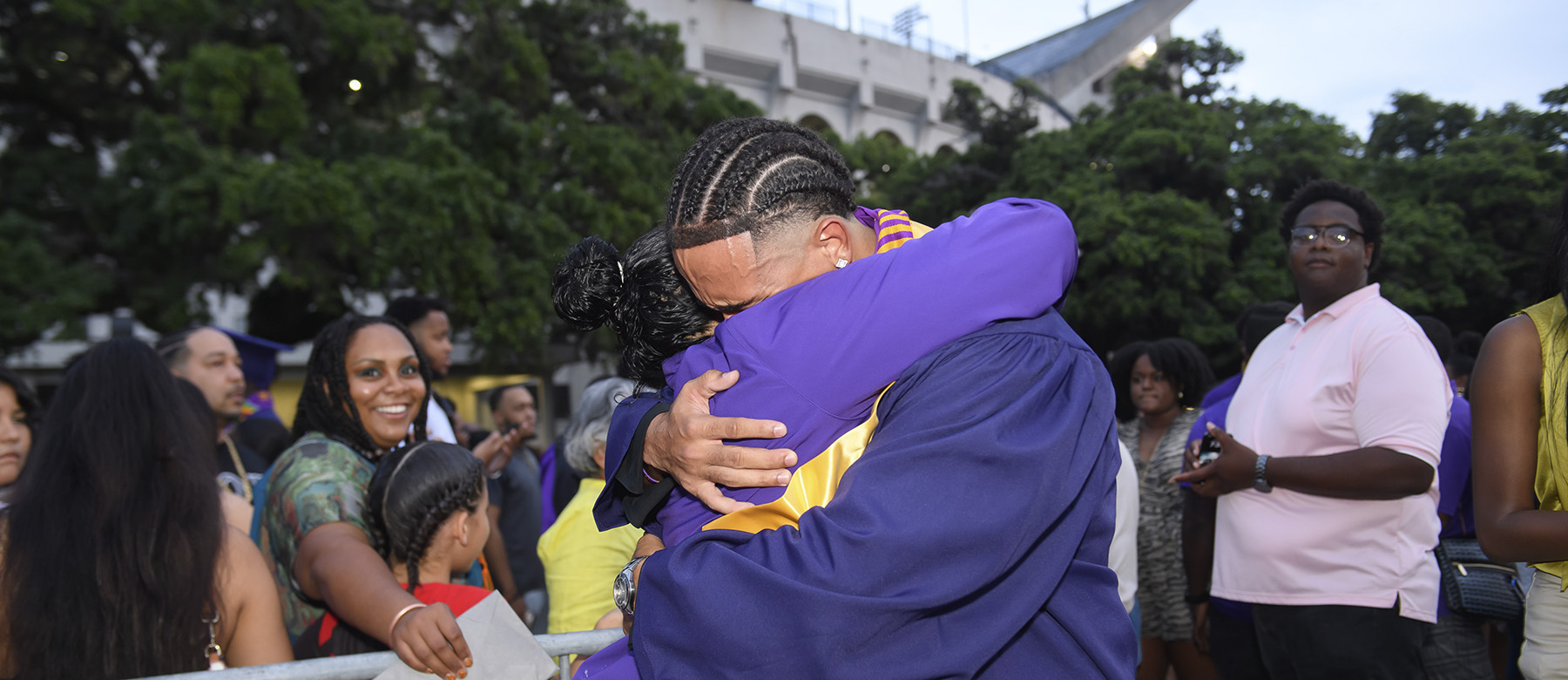 Mom hugging son at graduation