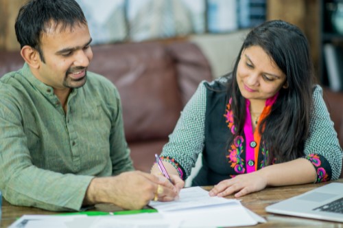 two people filling out forms