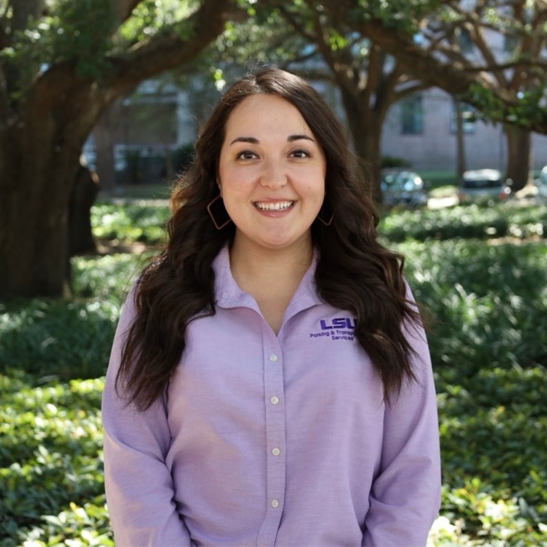 smiling woman in purple polo