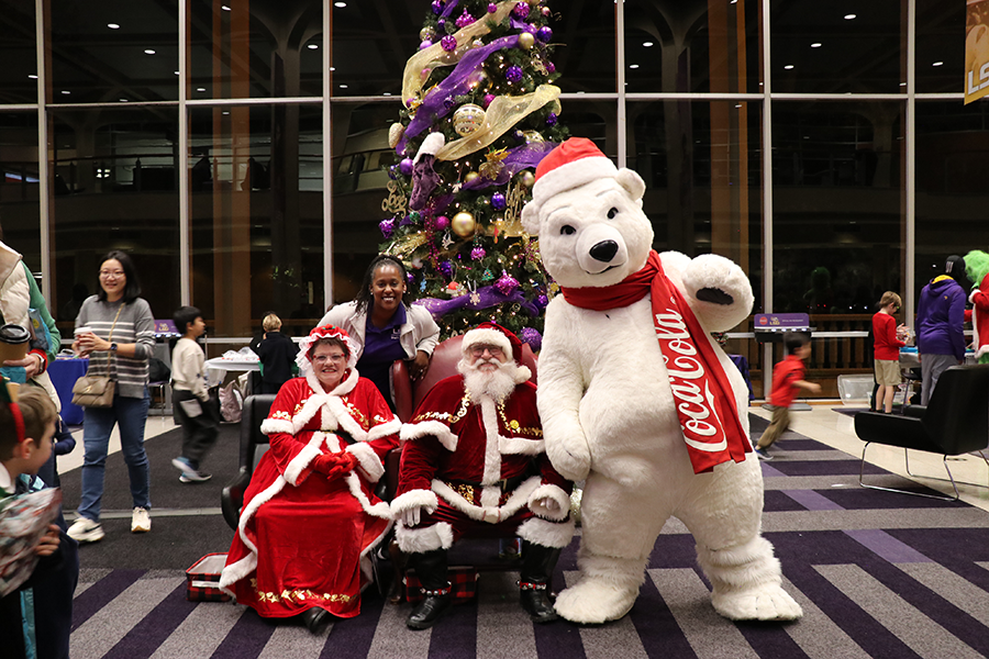 costumed staff with Santa and Mrs. Claus