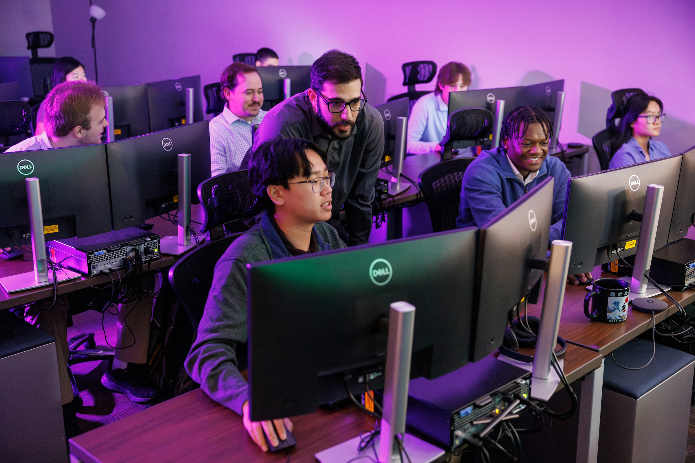 Students at computers with advisers assisting